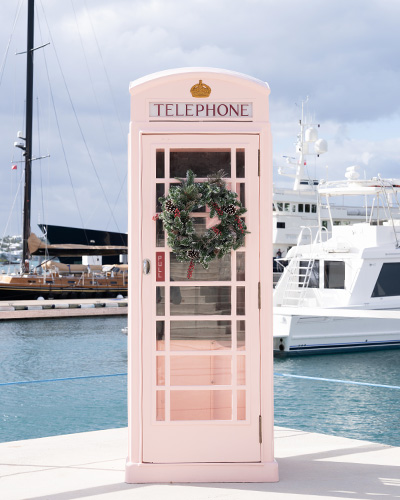 Hamilton Princess Christmas Offers - pink phone box at the marina with a christmas wreath attached