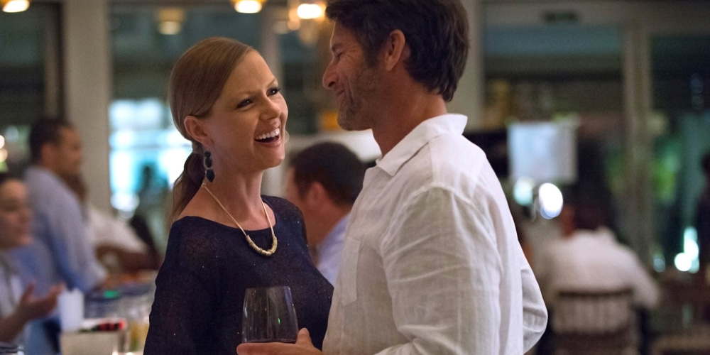 Stay Longer Enjoy More offer at the Hamilton Princess Bermuda - a couple having an evening drink in the hotel