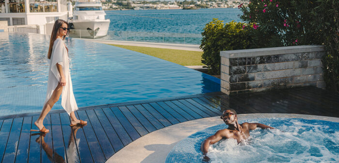 A couple relaxing by the pool in the Hamilton Princess Bermuda