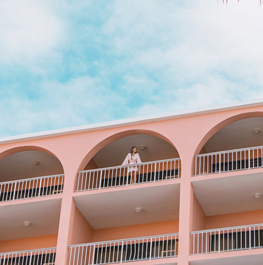 A woman standing on a balcony at The Hamilton Princess Bermuda