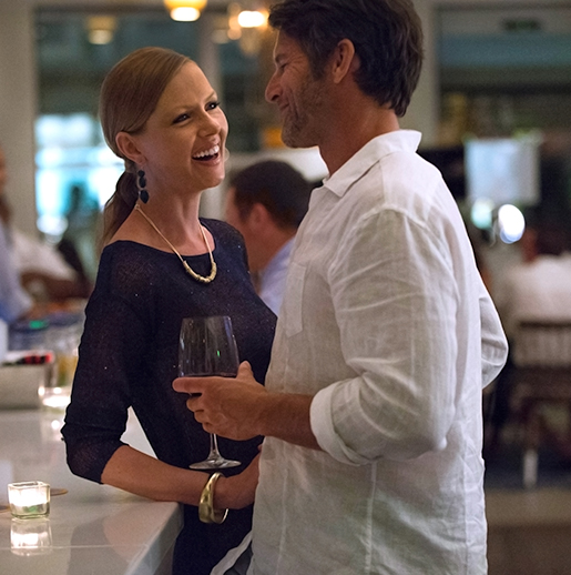 Stay Longer Enjoy More offer at the Hamilton Princess Bermuda - a couple having an evening drink in the hotel